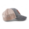 Right side profile of gray and tan mesh trucker cap featuring leather FNH Firearms patch and navy ‘Be Legendary’ patch.